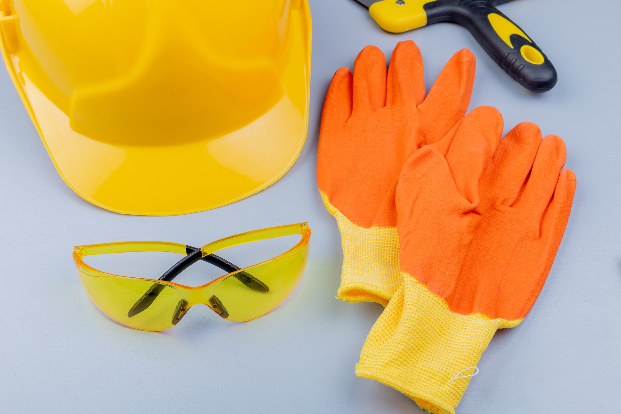 close-up view of pattern from set of construction tools as safety glasses safety helmet